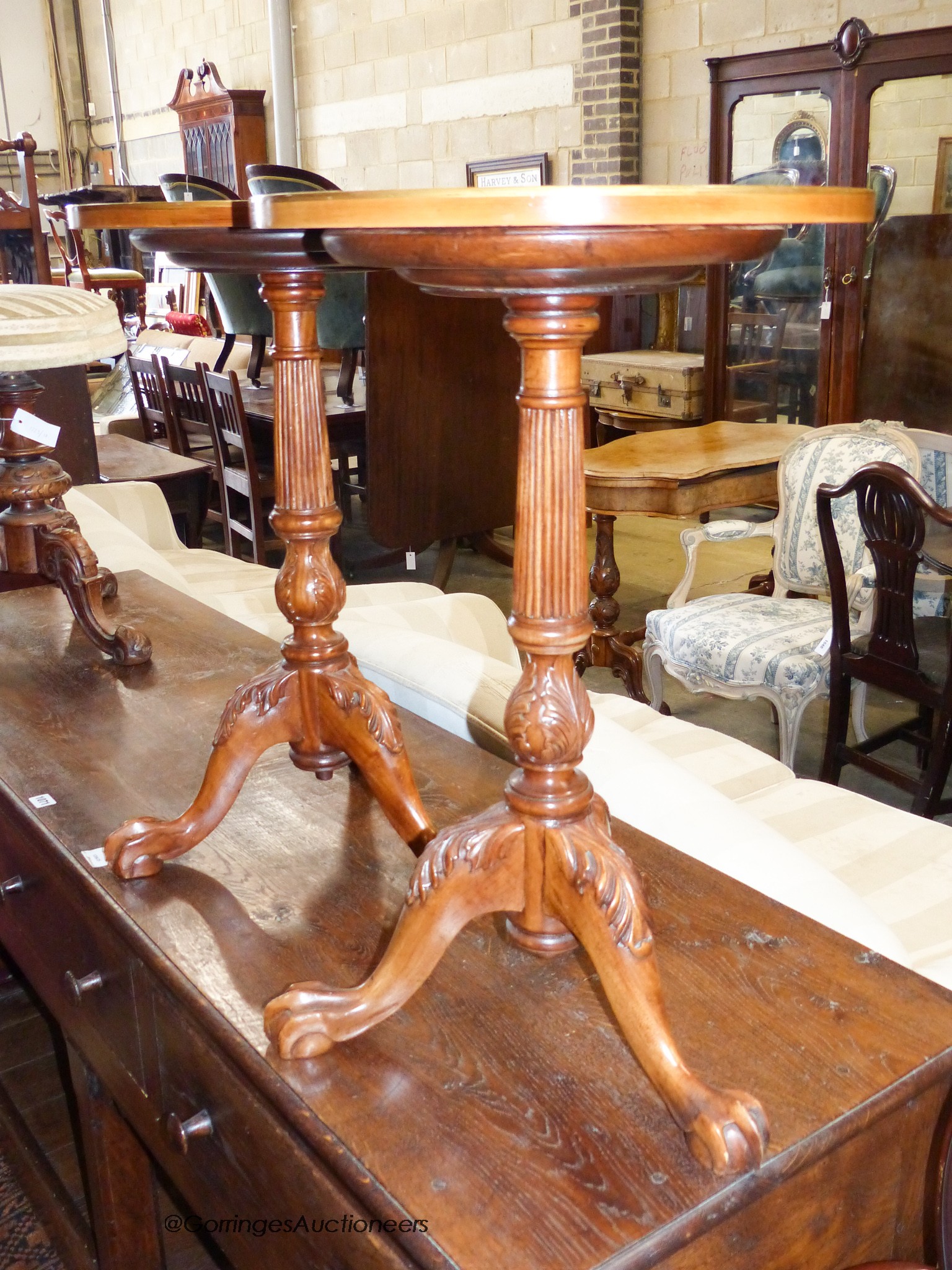 A pair of George III style painted satinwood and mahogany tripod wine tables. D-40, H-63cm.